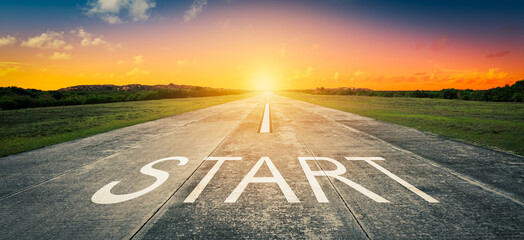 Conceptual image with word start on asphalt road at sunset.