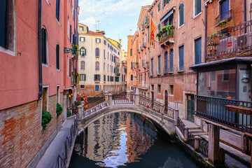 Fototapeta na wymiar Venice, Italy - June 22, 2023: Canal, bridge and ancient houses of Venice