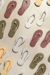 Female summer shoes, sandals as creative minimal pattern with hard shadow, beige brown white flip flops on beige gradient color background. Aesthetic trend summer fashion concept, life style photo