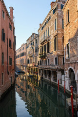 Obraz na płótnie Canvas Venice, Italy - June 22, 2023: Canal, bridge and ancient houses of Venice