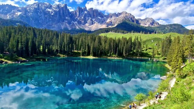 Idyllic nature scenery- trasparent mountain lake Carezza surrounded by Dolomites rocks- one of the most beautiful lakes of Alps. South Tyrol region. Italy