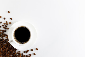 Coffee cup and beans on white background.