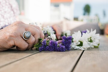 woman holding her midsummer flower crown in Sweden