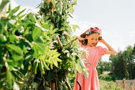 young girl helping decorate the midsummer pole in Sweden