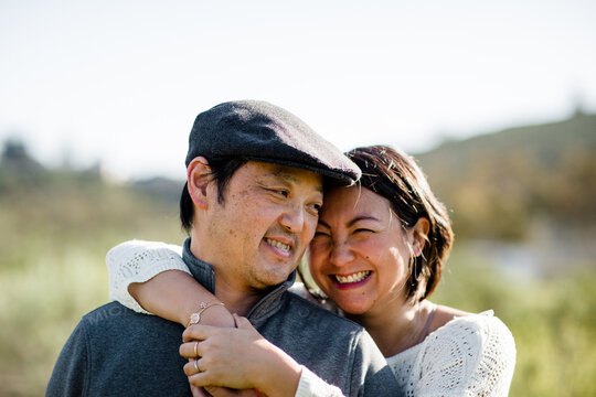 Close Up of Asian Husband & Wife in Field in San Diego