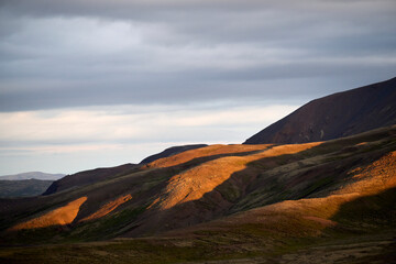 Uneven mountain slope with sunlight