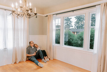 couple enjoying a tender moment in their new empty home