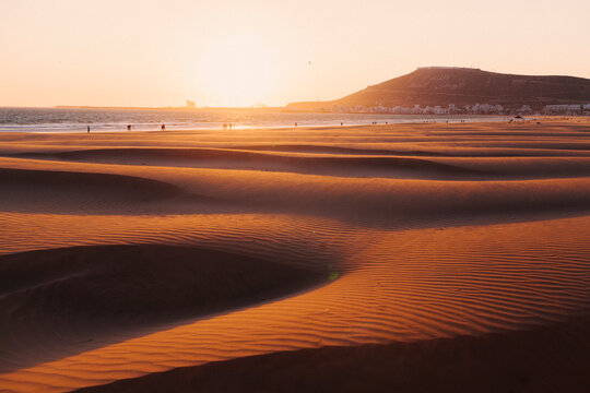 The sunset on a sandy beach in Agadir, Morocco.