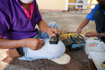 Technician working, fiber optic cable splicing and testing cables with optical power meter  - obrazy, fototapety, plakaty