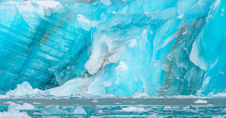 A close-up of the layered surface of a blue glacier - Knud Rasmussen Glacier near Kulusuk -...