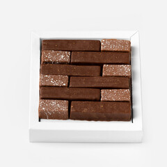 Handmade chocolates in package isolated on white background.
