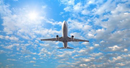 White passenger airplane flying in the sky amazing clouds in the background - Travel by air transport