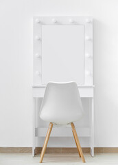 White makeup dressing table with lamps and a chair against a white wall