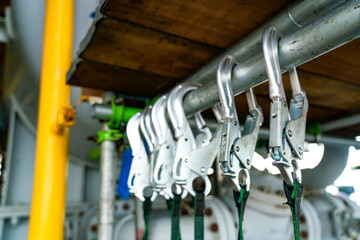 An anti-fall hook and loop strap for floor work is attached to the scaffolding beam.