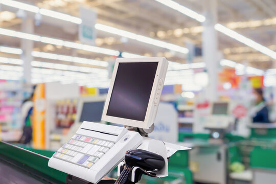 Empty cashier checkout desk with terminal in supermarket