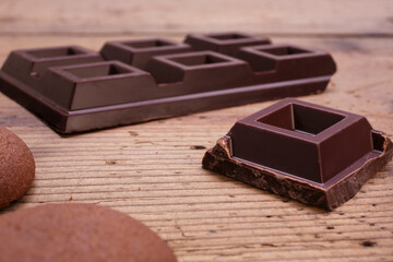 dark chocolate squares on rustic wooden table
