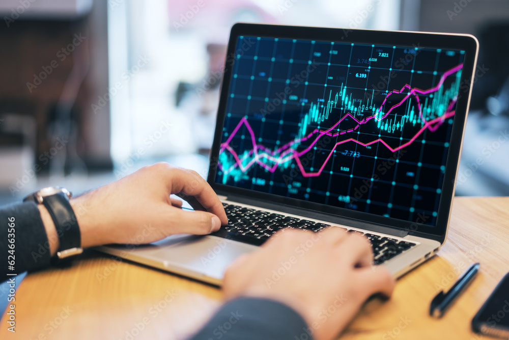 Poster close up of male hands using laptop at wooden desk with glowing forex index chart with grid on blurr