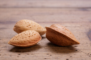 Almonds in shell on wooden rustic table