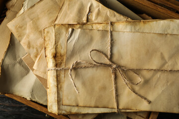 Box with old letters on wooden background, close up