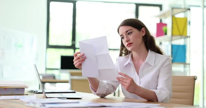 Female entrepreneur opens received letter from tax service and gets upset. Businesswoman against laptop finds out about company ruin. Bankruptcy of small business