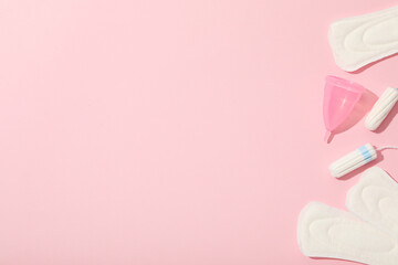 Menstrual feminine hygiene products on a pink background