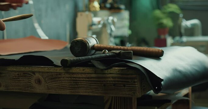 Male shoemaker preparing his professional tools for work at the workshop. 