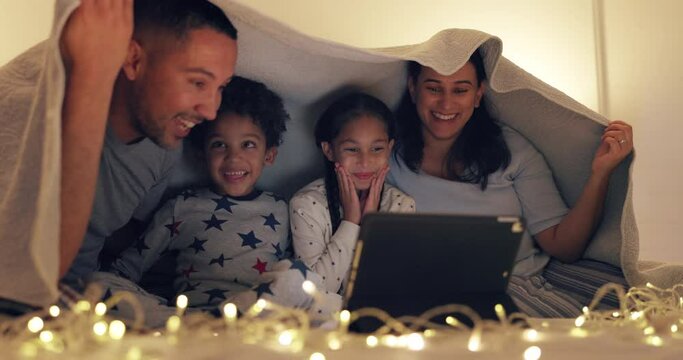 Laptop, parents and kids in bed for movie at night, streaming television show and smile at home. Mother, father and children in bedroom at sleepover to watch tv, relax and bonding with online video.