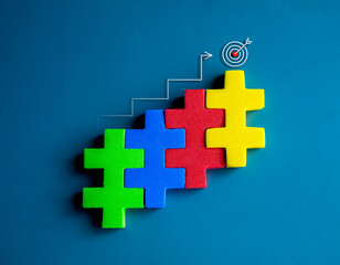 Obraz premium Target icon on top of colorful puzzle blocks bar graph chart steps with step up arrows on blue background, minimal style. Business growth process, profit, investment, economic improvement concepts.