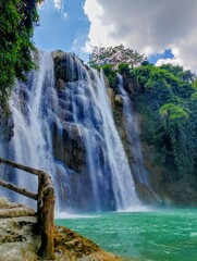 The beutiful waterfall in Indonesia with the blue water and good enviroment.