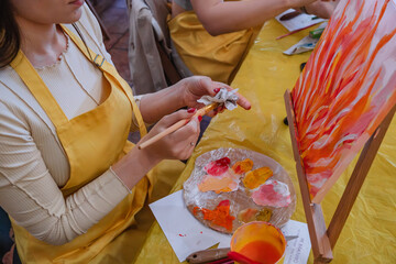 woman hand holding brush paint on canvas