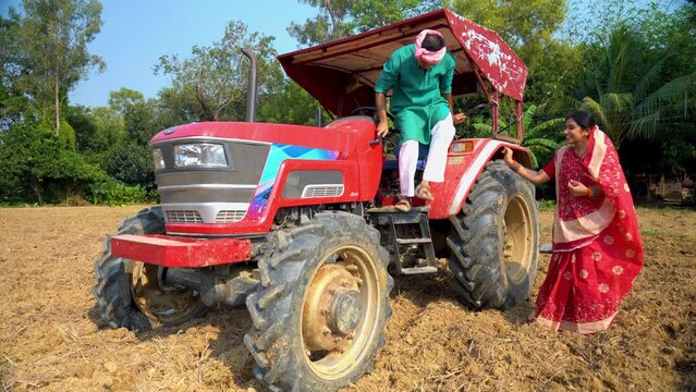 An Indian fFarmer dismounts from his tractor, ready to tend the land with dedication and optimism. A Happy Farmer Family.Jai Kishan!