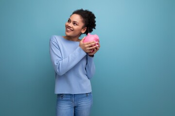 20c young afro hair brunette woman trying to count her piggy bank savings