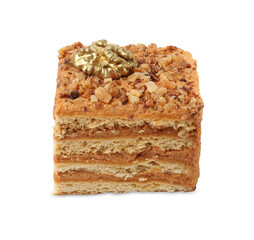 Piece of layered honey cake with walnuts on white background