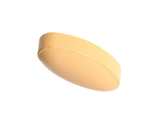 One pale orange pill isolated on white