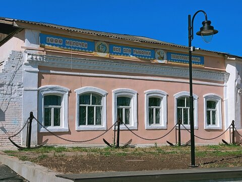 Kozmodemyansk, Republic of Mari El, Russia - 08.28.2021. An old building with a shop on Karl Marx Square