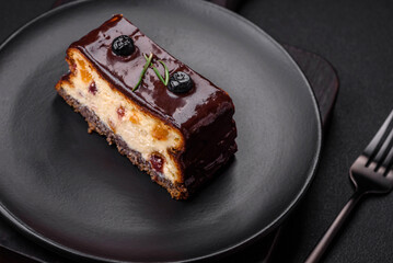 Delicious sweet dessert cheesecake with candied fruits in chocolate