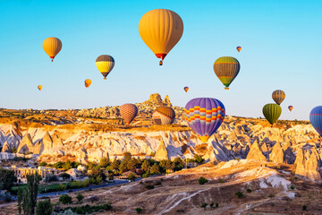 Colorful hot air balloons over Cappadocia, Turkey at sunrise sunset time. Amazing view on...