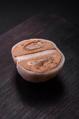 Delicious sweet mochi dessert with toppings on a dark concrete background