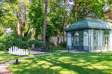 Giant chess on board located on ground green grass in park- intellectual game. Jurmala. Latvia 