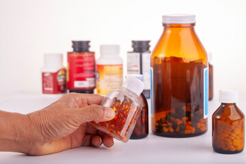 medicine bottle in hand  and bottles of medicine white background.
