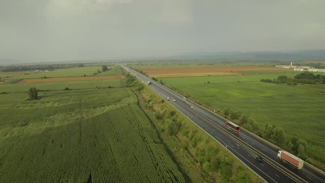 4K aerial video from above with A1 highway road between Sebes and Deva. Drone video with the roads of Romania. Aerial view during sunset after a summer storm.