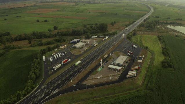 Sebes, Romania - 5 July 2023: Aerial 4K video over A1 highway road in Romania and the Rompetrol gas stations next to Hunedoara and Sebes. Parking service and gas stations on highway.