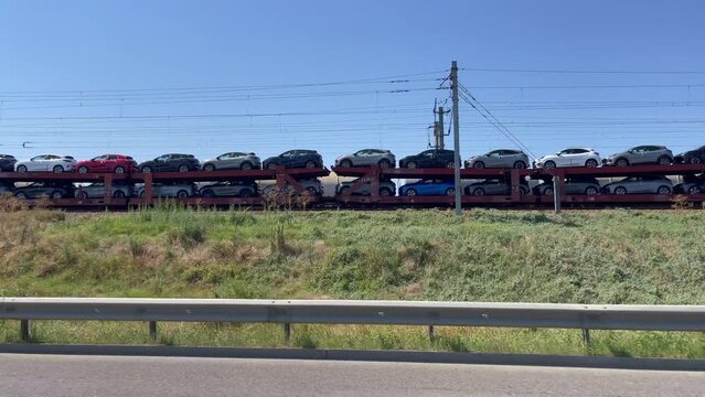 Constanta, Romania - 3 July 2023: Cargo train with a lot of Ford Puma cars going for export outside Romania. Ford Puma cars are manufactured in Craiova. Automotive industry 4k video.
