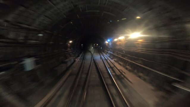 Point of view from the railway cabin. Concept of morning commute. Time lapse of subway train moving at tunnel. Fast speed underground train riding in a tunnel of the modern city. Timelapse POV
