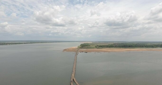 aerial backwards  the long bamboo bridge connects to the Kampong Cham town to the Koh Penh island