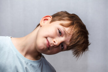 nine year old boy looks at the camera and smiles. close-up portrait