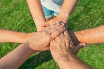 Joined hands as a team. Business teamwork. Close up group of multiracial friends meeting join hands together. Diversity people. Partnership volunteer community. Diverse multiethnic Partners. Top View