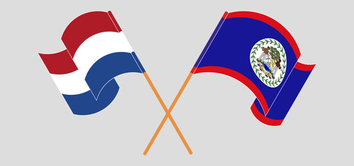 Crossed and waving flags of the Netherlands and Belize