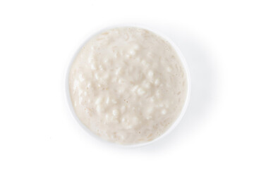 Rice pudding. Arroz con leche. Rice pudding in white bowl isolated on white background. Top view