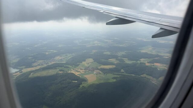 View from window of airplane flying over Bavaria, Germany in summer